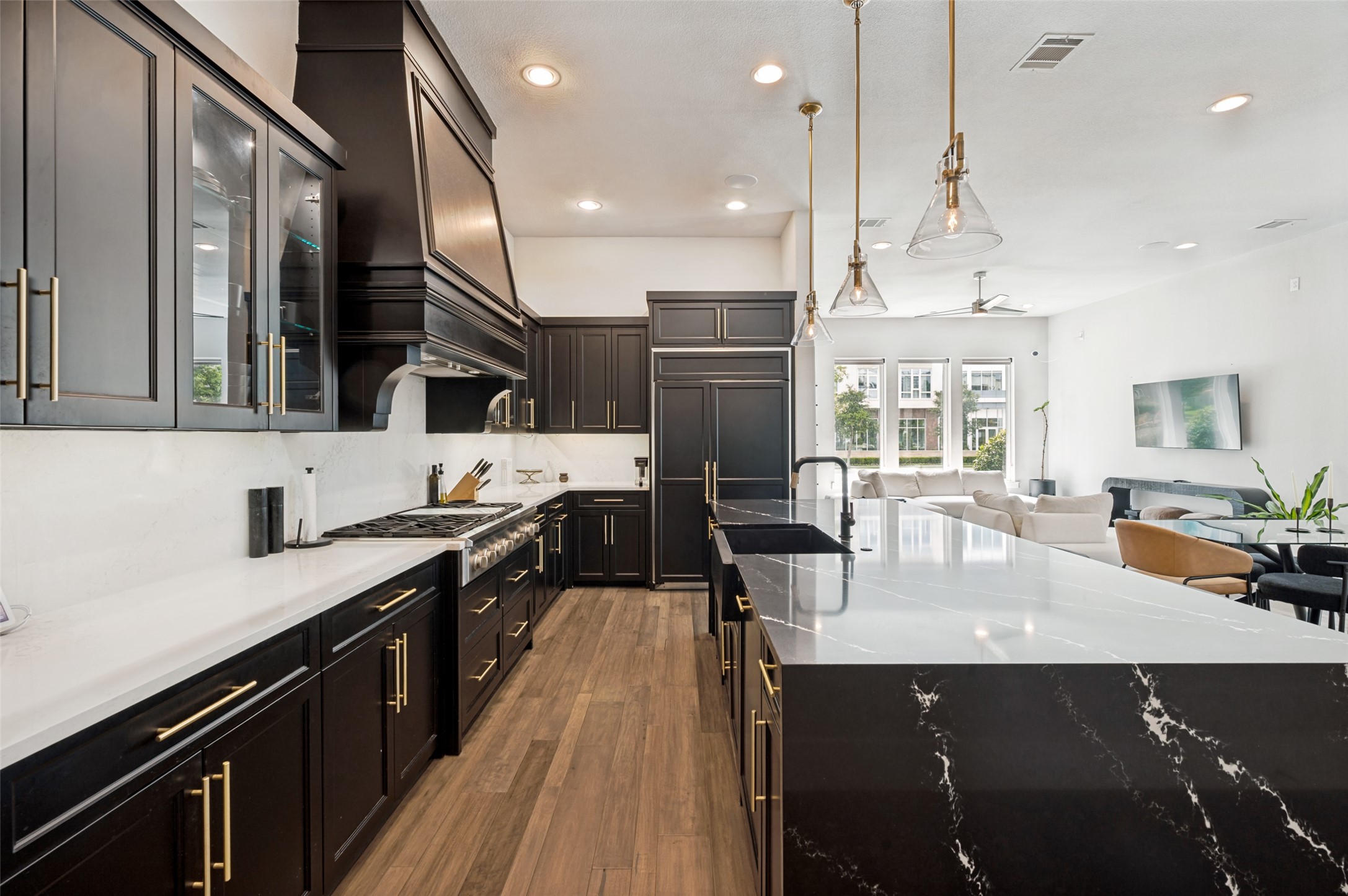 Kitchen island looking toward the connected dining and living areas at 7820 Merit Lane